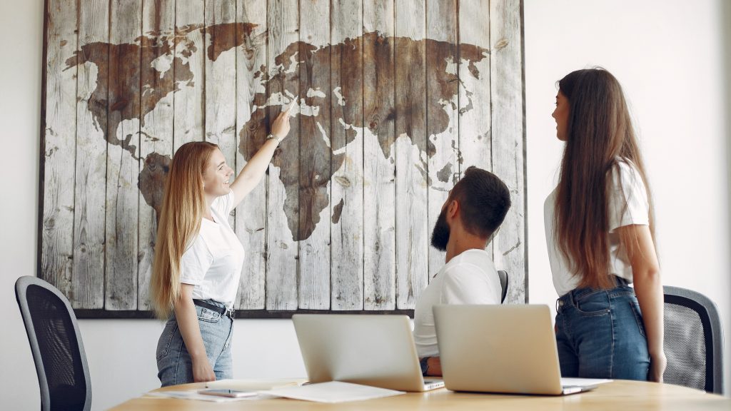 Young team working together And looking at the world map.