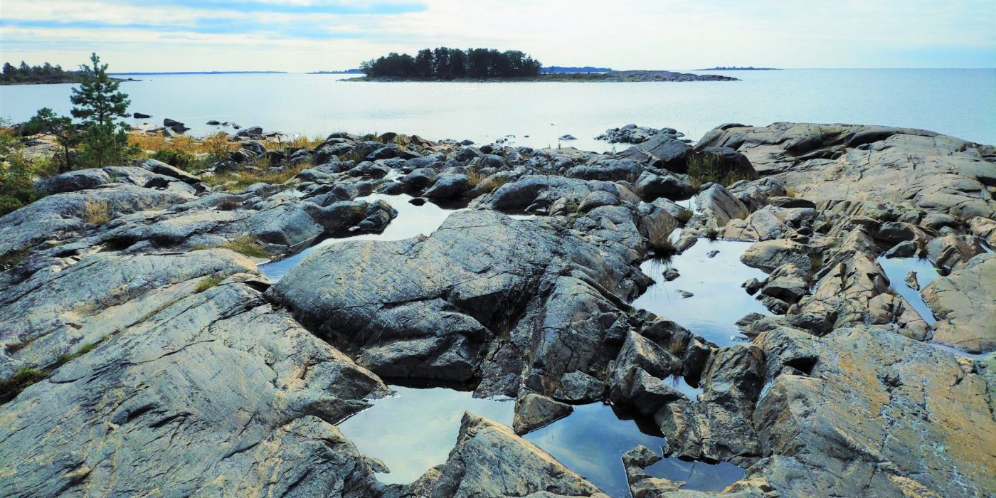 Illustration showing a rocky coastal landscape.