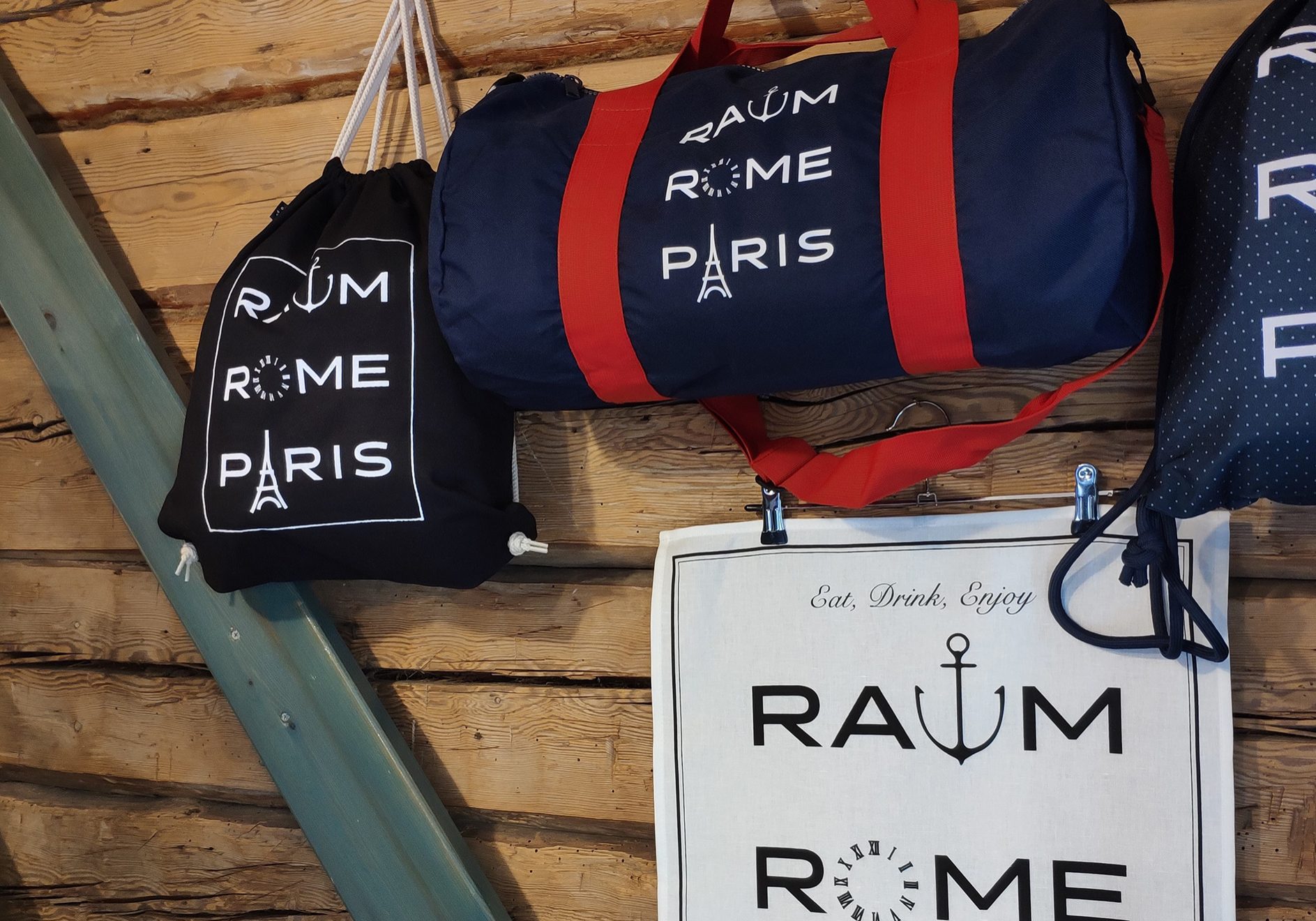 Raum. Rome. Paris. Bags hanging on the wall.