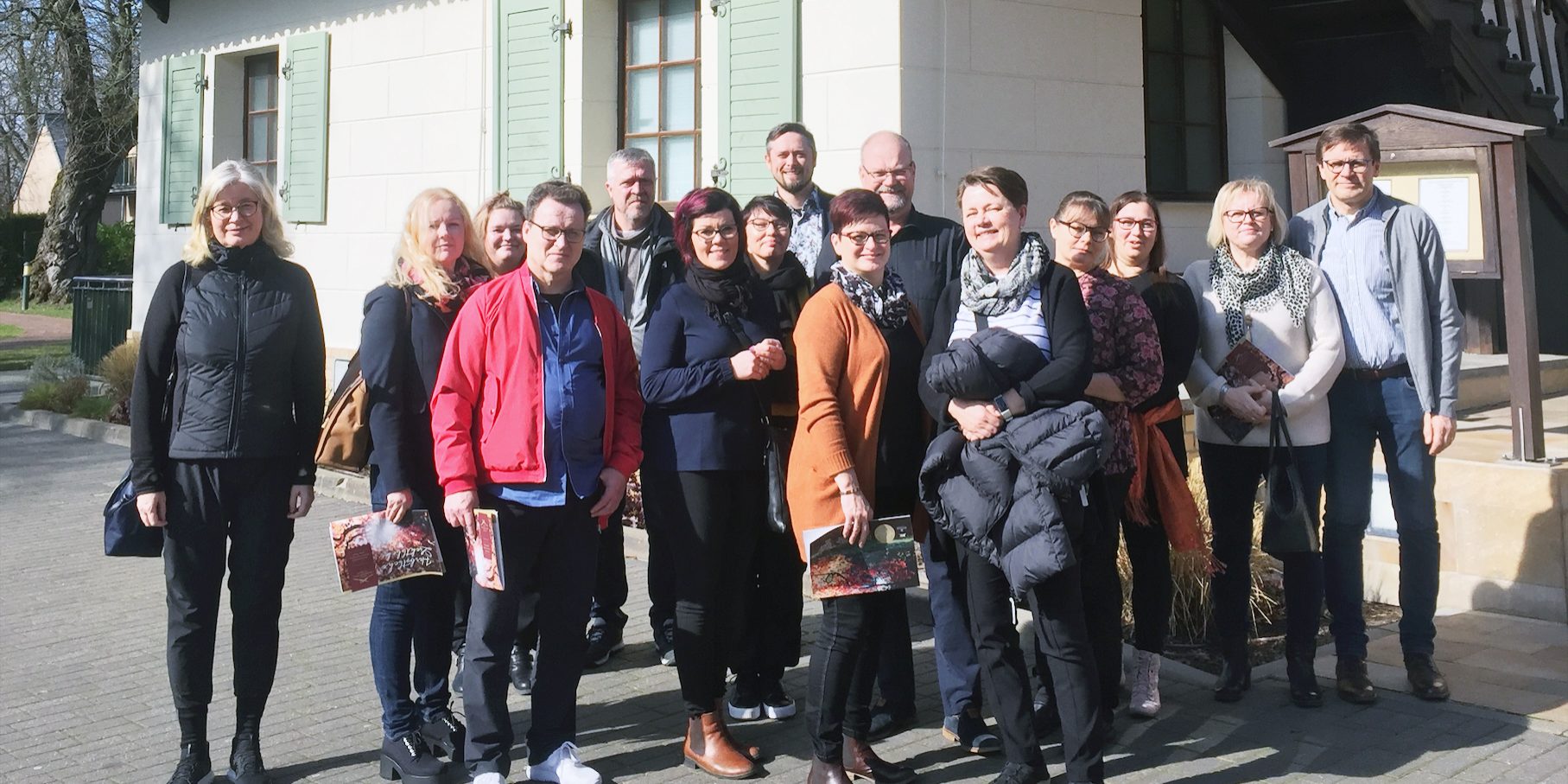 German study tour group in a group photo in front of the building.