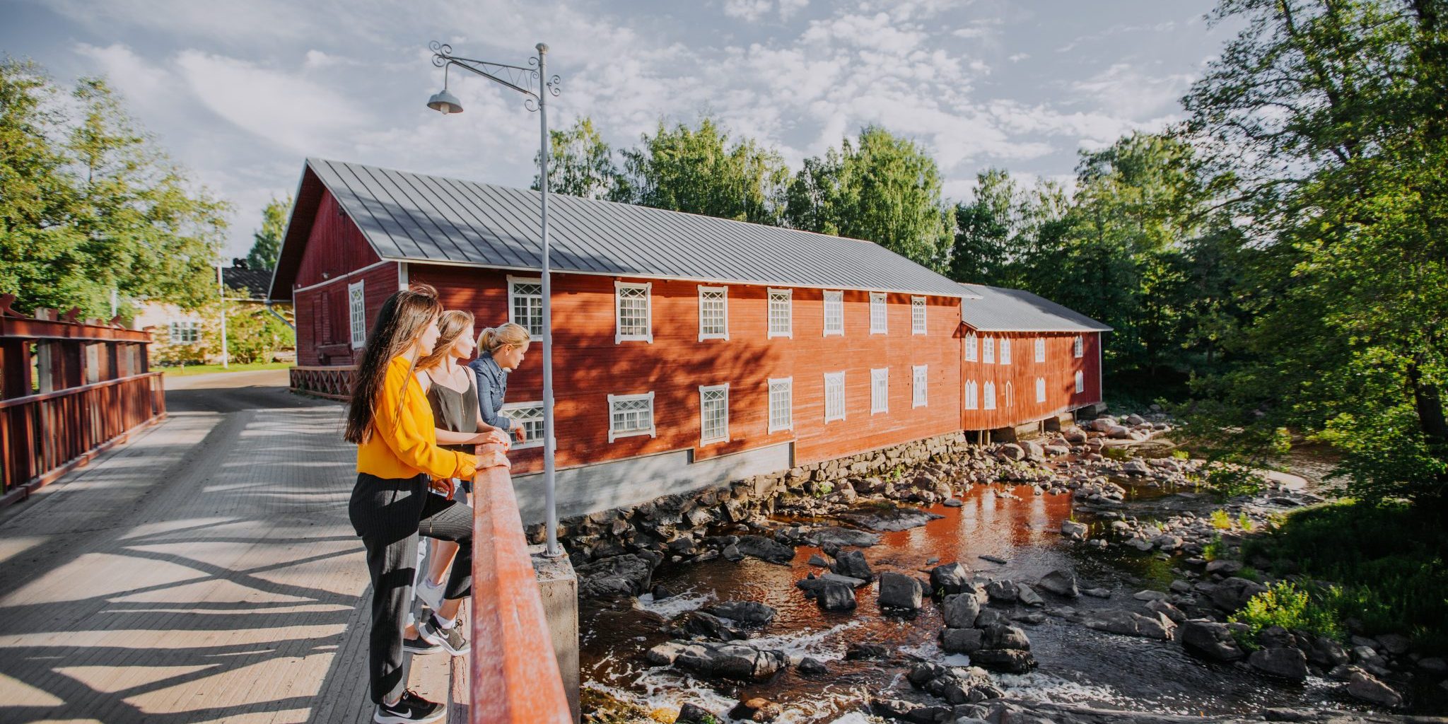 Illustration of two people hiking on a wooden bridge in nature.