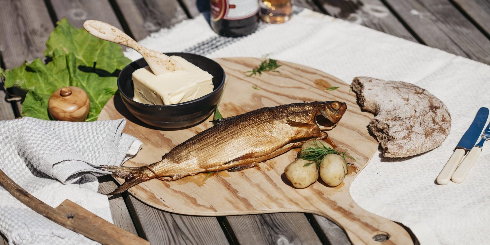 Local smoked fish and other produce on a table.