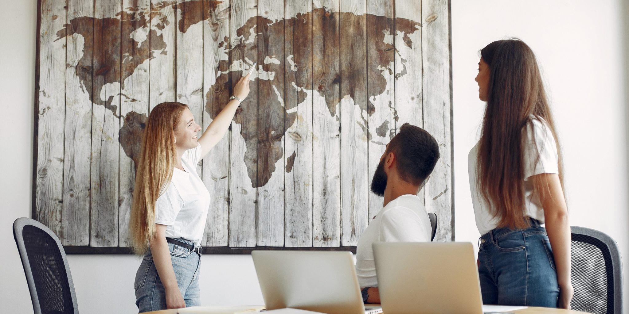 Young team working together And looking at the world map.